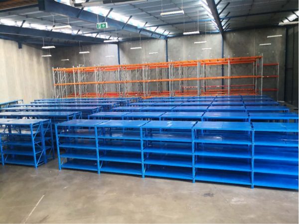 Warehouse fit-out with blue steel shelving units and pallet racking system in industrial facility New Zealand