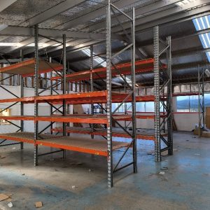 Used pallet racking with wooden shelf